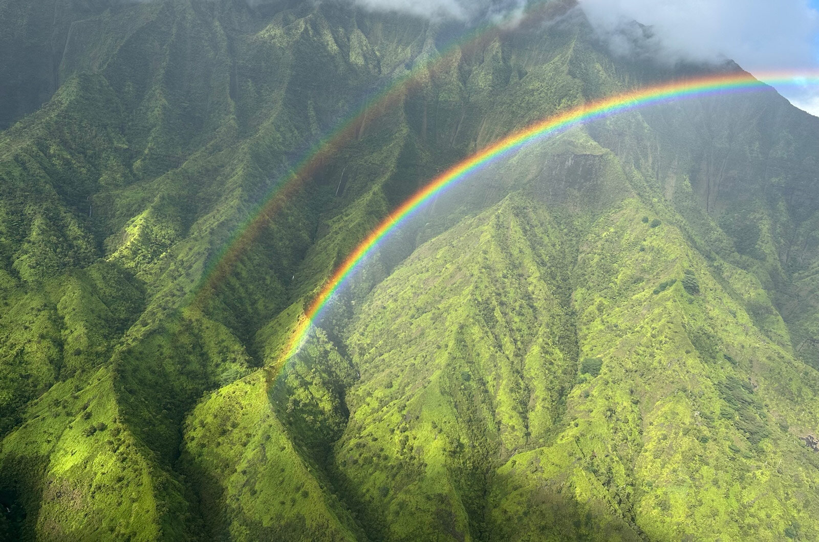mountains in kauai with rainbow 