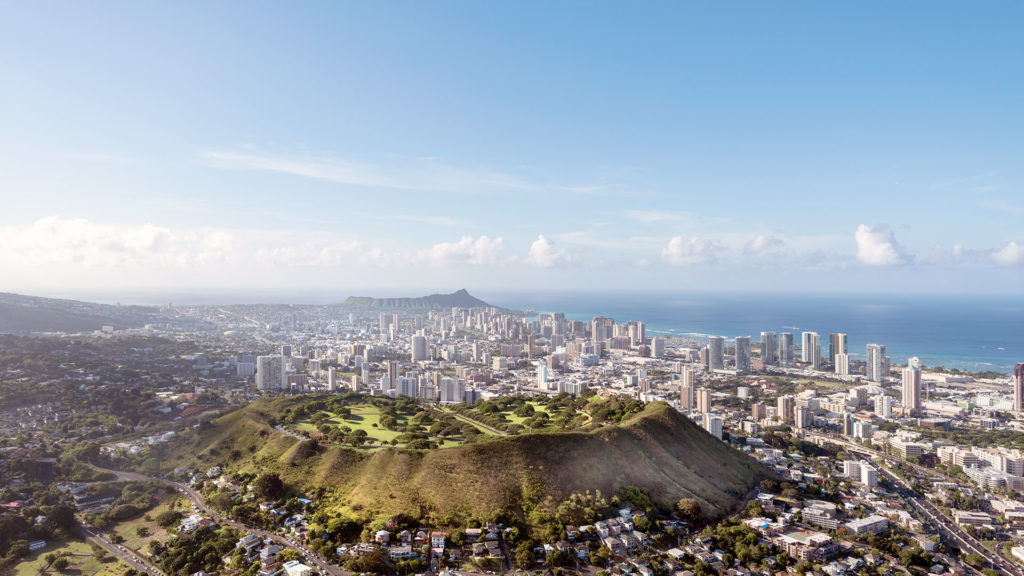 a city with a hill and a body of water